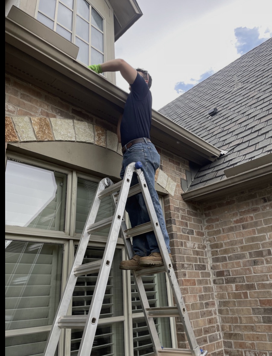 Reliable Gutters and Exteriors crew member working on a gutter installation